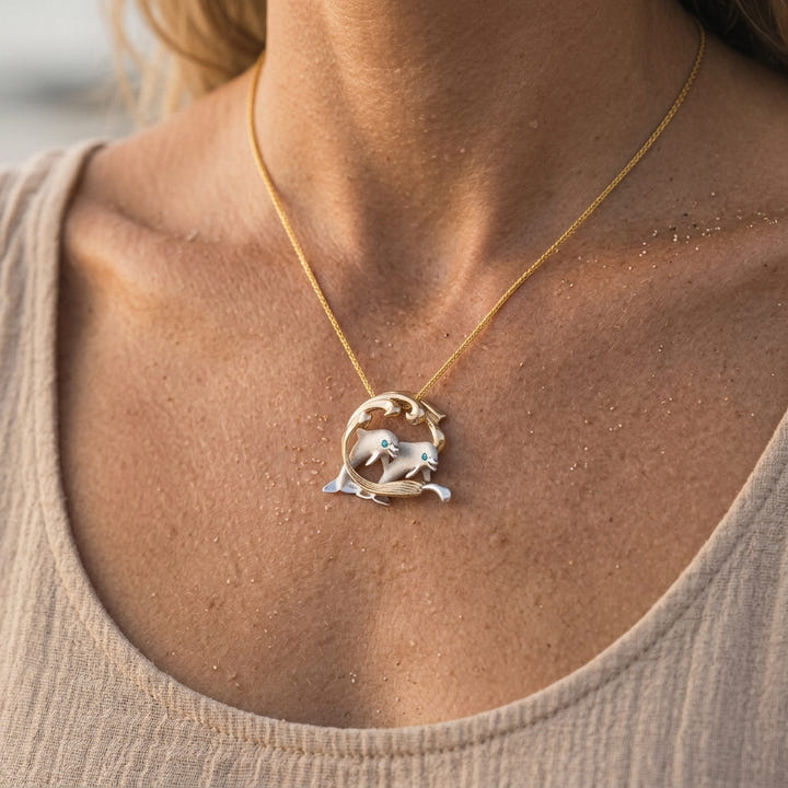 14k 2/tone 25mm Surfing Dolphin Pendant with 2 Blue Diamonds — worn on model (blonde, view 4)