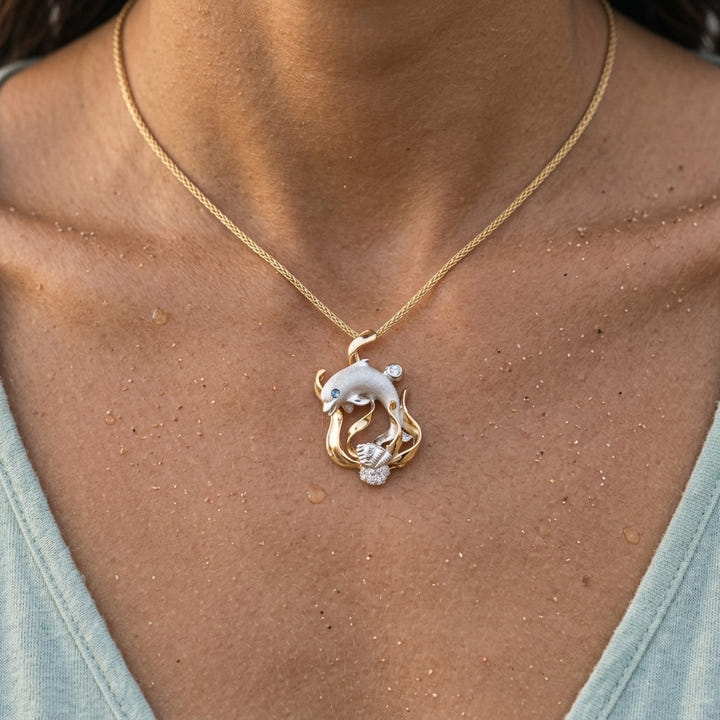 14k 2/tone "Blue Lagoon' Dolphin Pendant with 0.01 carat blue diamond — worn on model (brunette, view 4)