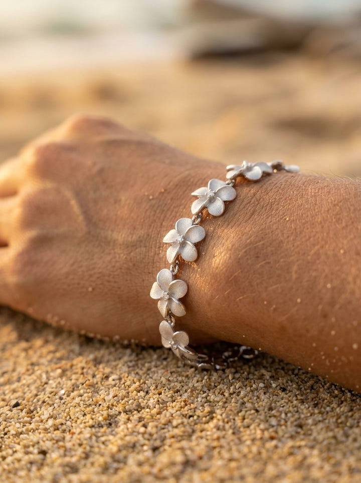 14k 11mm Plumeria Bracelet 7" with 13 diamonds and 13pc flowers — close-up on model