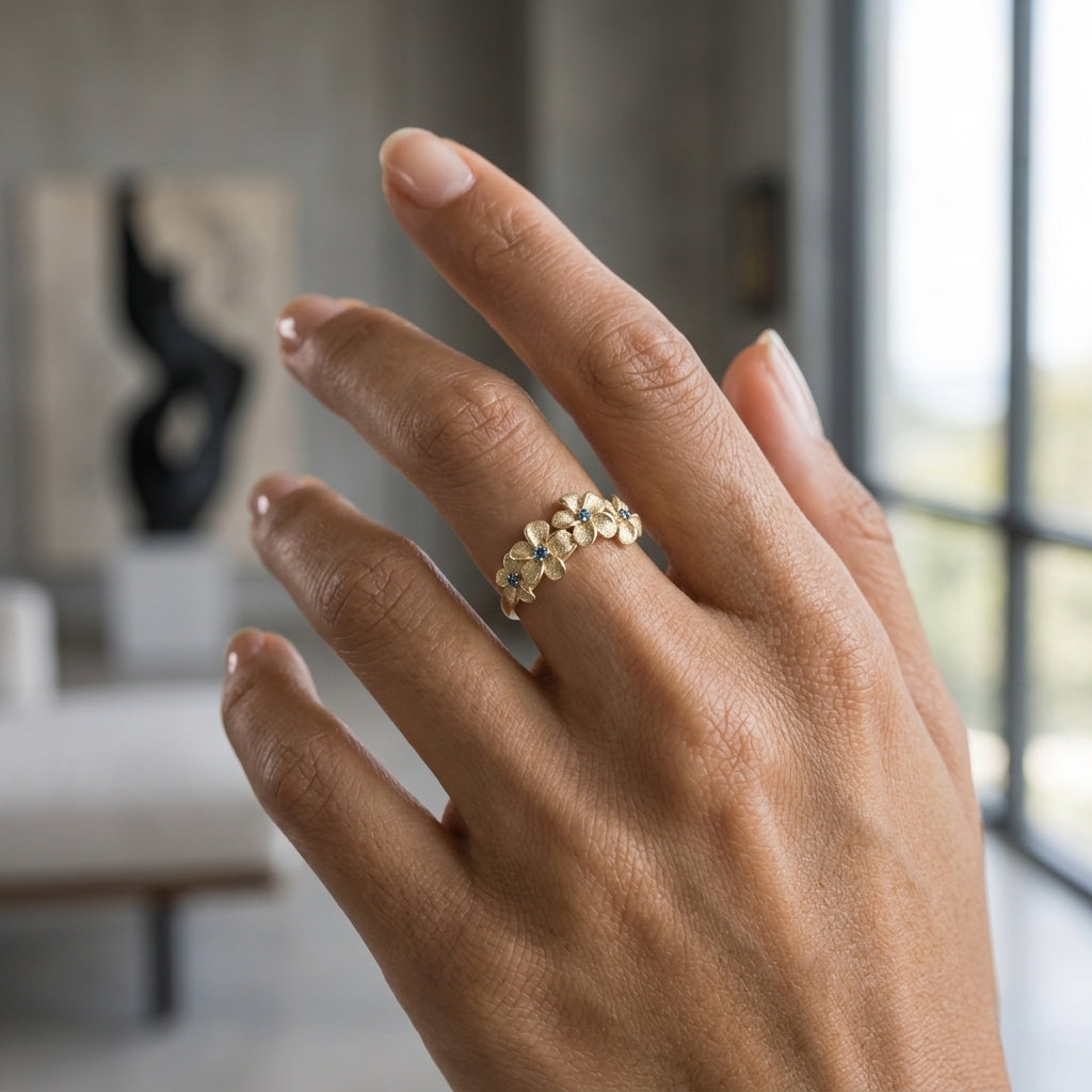 14k 8mm Plumeria Ring with 4 Blue Diamonds — worn on model (brunette, view 2)