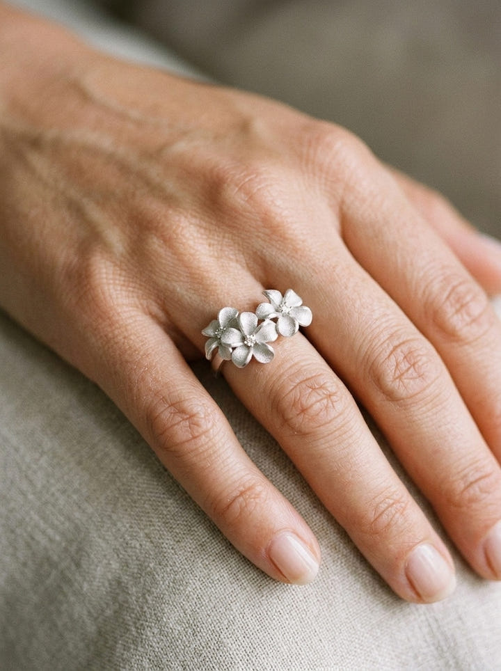 8mm 14k Plumeria Ring with 3 diamonds — close-up on model