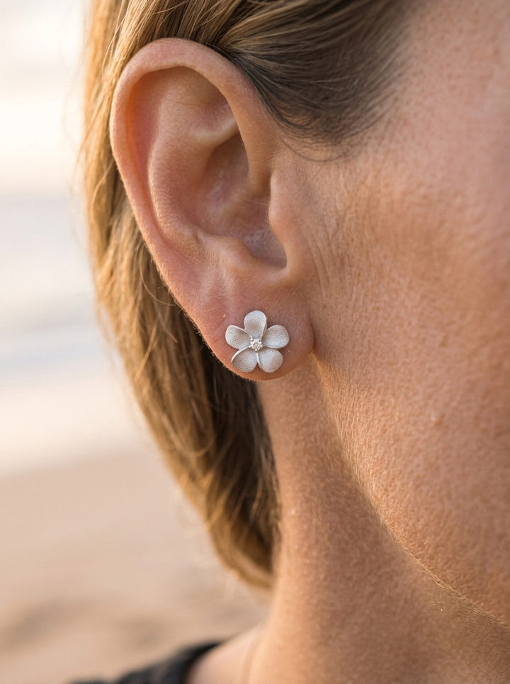 14k 11mm Plumeria Earring with 2 diamonds — close-up on model