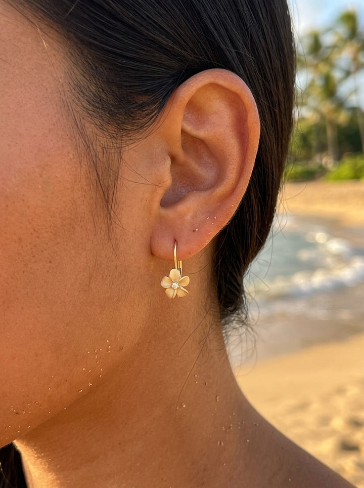8mm 14k Plumeria Earrings with 2 diamonds — close-up on model