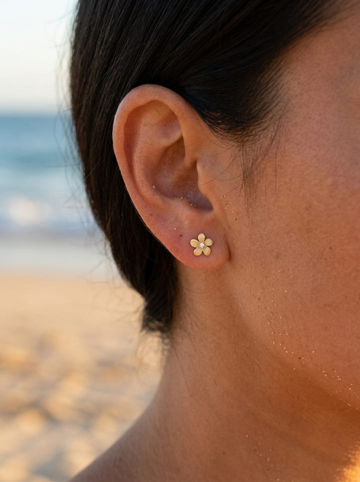 14k 6mm Plumeria Earrings with 2 Diamonds — close-up on model