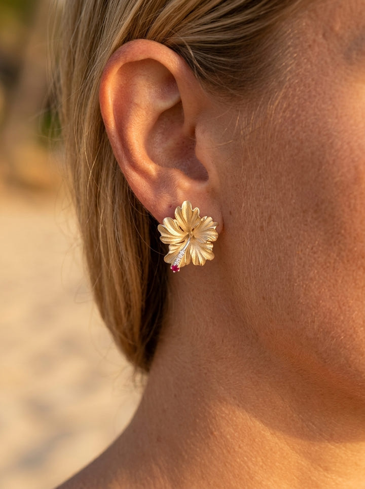 20mm 14k Hibiscus Earring with 6 diamonds and 2 rubies — close-up on model
