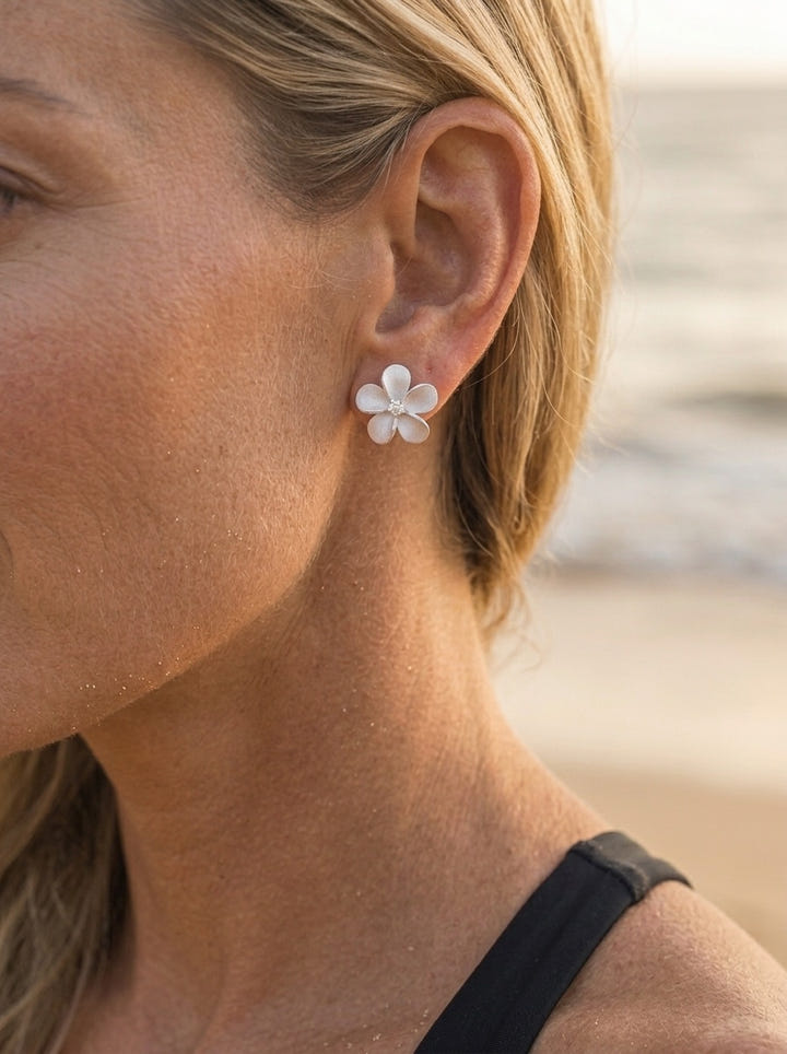 Precious Silver 15mm Plumeria Earrings with 2 White Sapphire — close-up on model