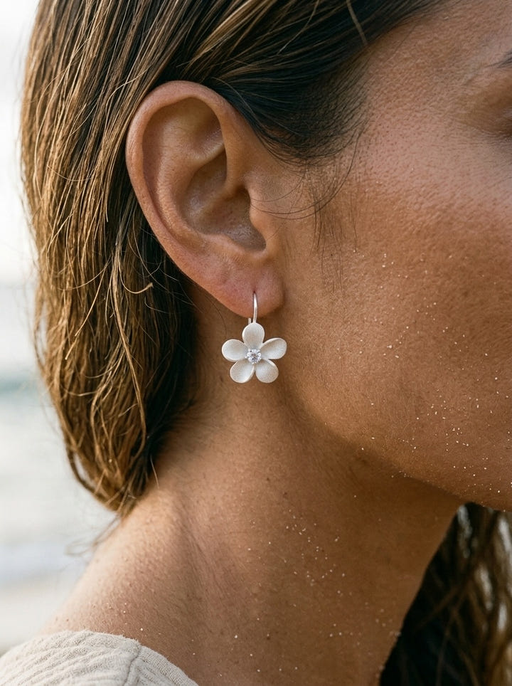 11mm Precious Silver Plumeria Earrings with 2 White Sapphire — close-up on model