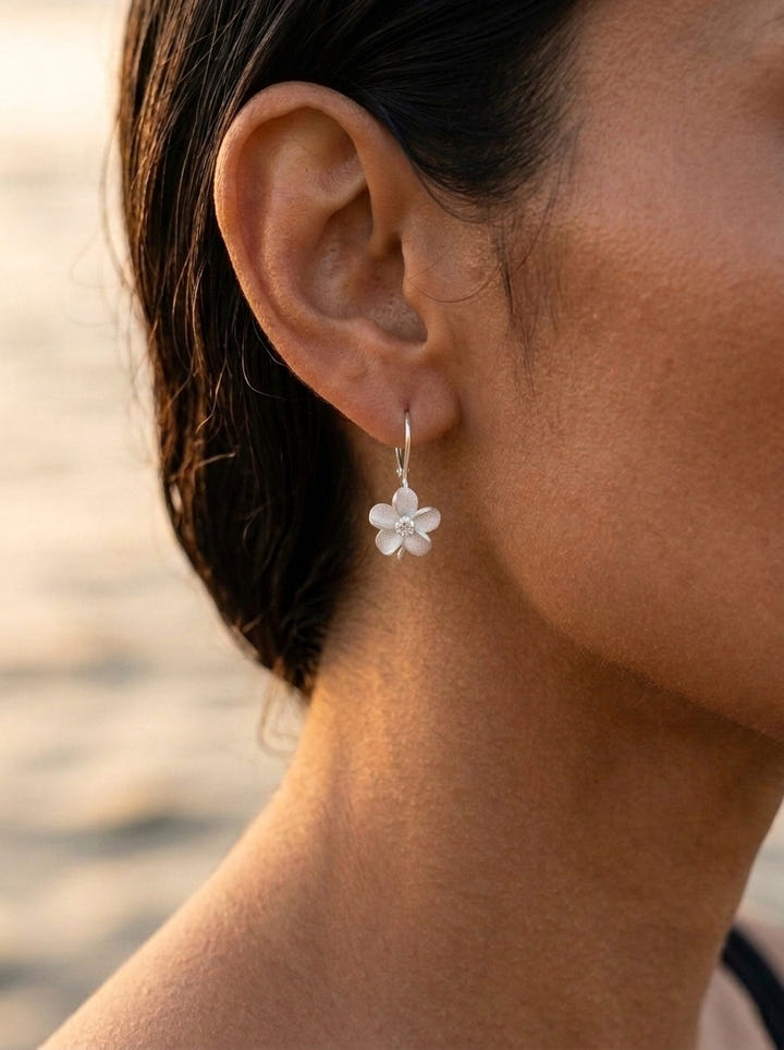 Precious Silver 8mm Plumeria Earrings with 2 White Sapphire — close-up on model