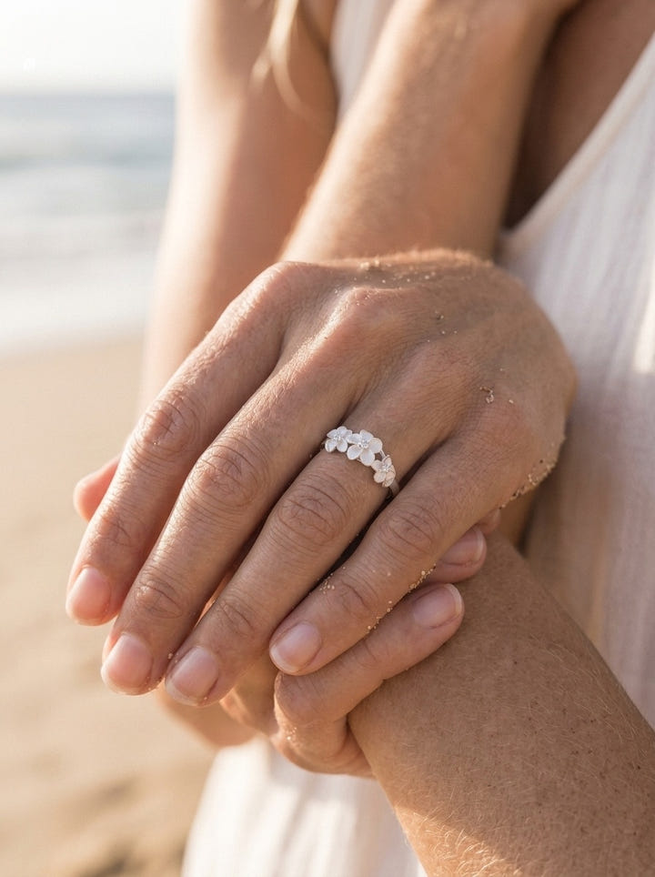 8mm Precious Silver Plumeria Ring with 3 White Sapphires — close-up on model