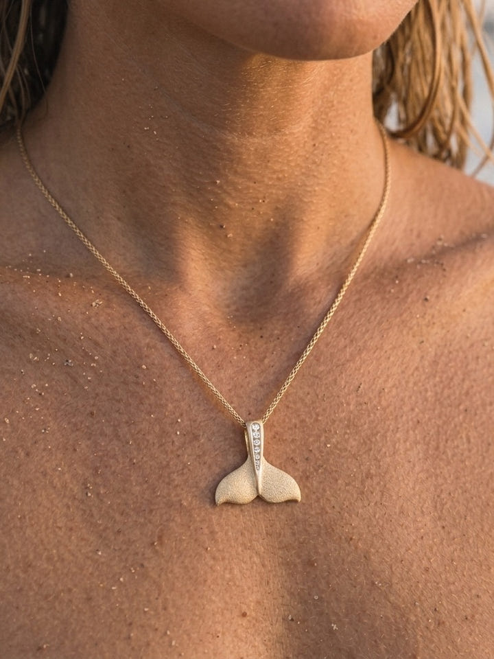 14k 20mm Whale Tail Pendant with 6 Diamonds — close-up on model