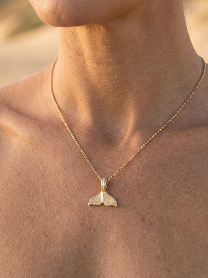 14k 15mm Whale Tail Pendant with 5 Diamonds — close-up on model