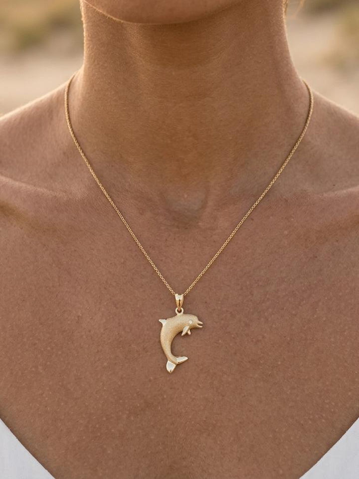 14k 20mm "Jumping Single" Dolphin Pendant with 0.01 carat diamond — close-up on model