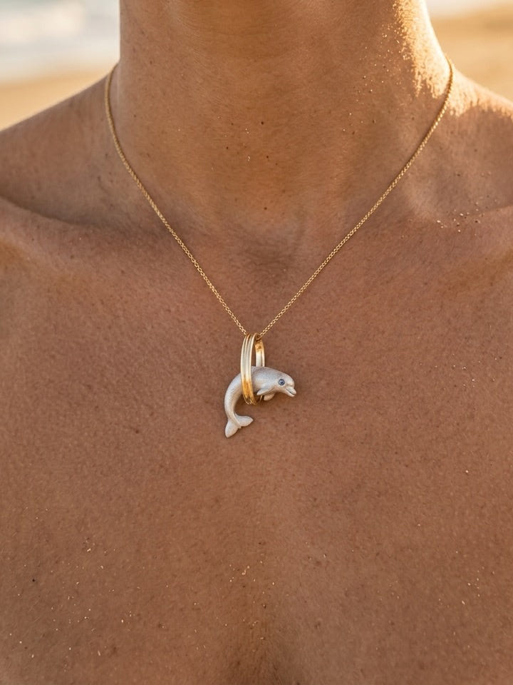 14k 15mm "Jumping Loop" Dolphin Pendant with 0.01 Blue Diamond — close-up on model