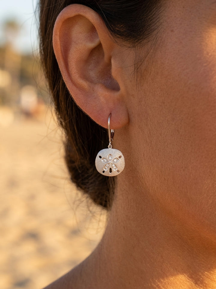 10mm 14k Sand Dollar Earring with 10 diamonds — close-up on model