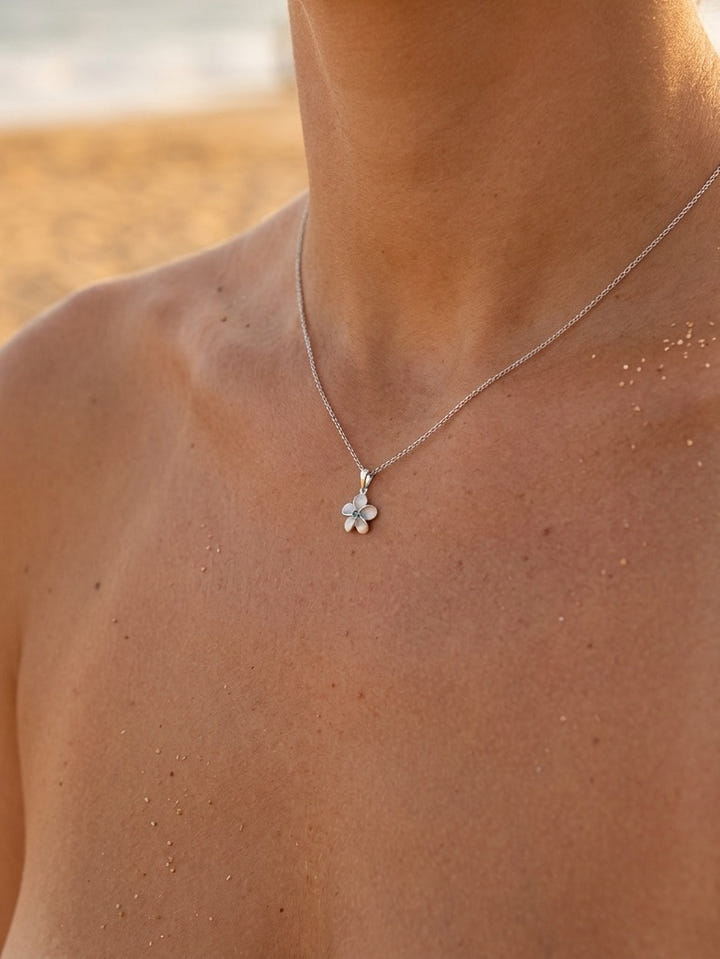 8mm 14k Plumeria Pendant with 0.02 carats blue diamond — close-up on model