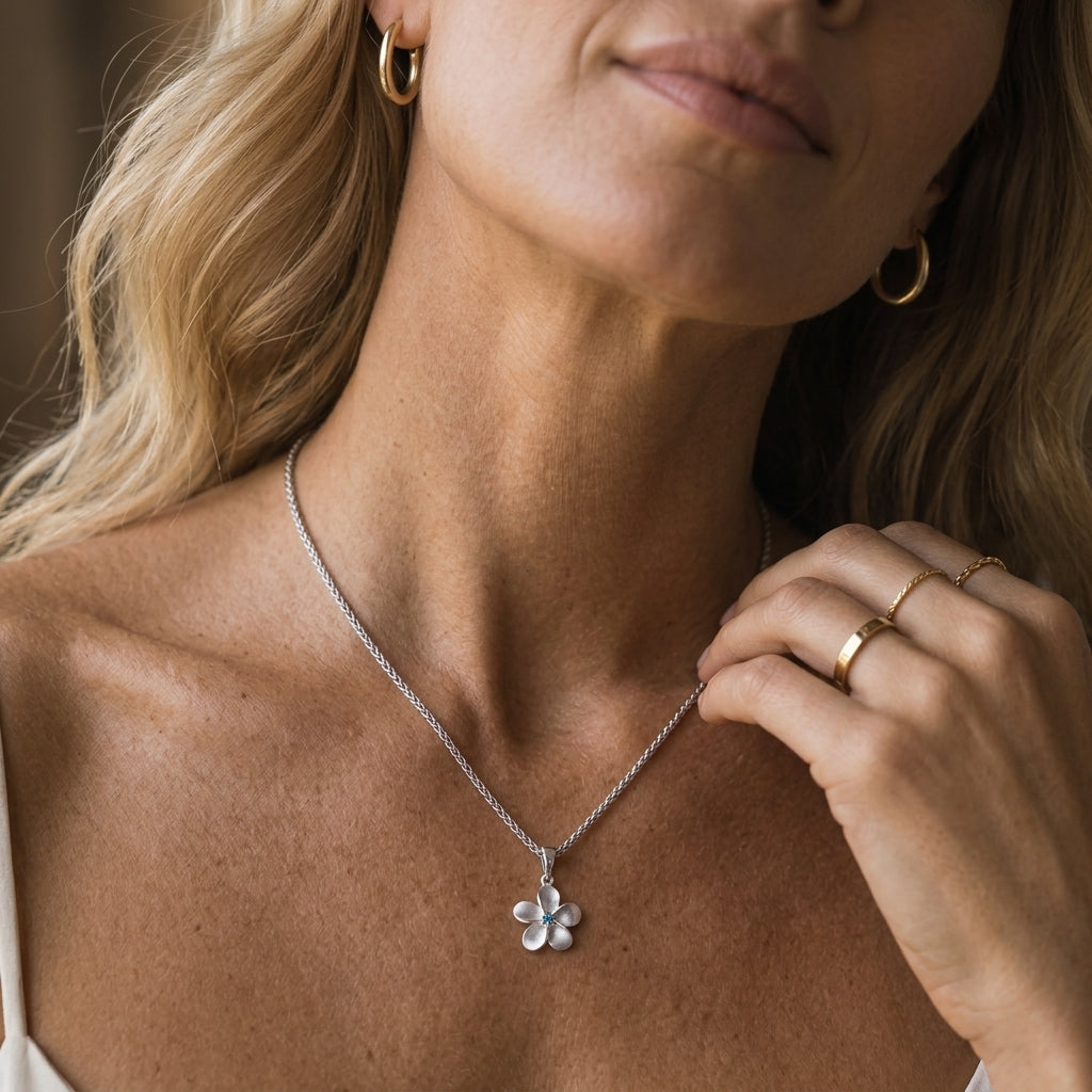 8mm 14k Plumeria Pendant with 0.02 carats blue diamond — worn on model (blonde, view 1)