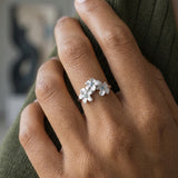8mm 14k Plumeria Ring with 3 blue diamonds — worn on model (brunette, view 3)