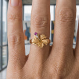 15mm 14k Hibiscus Ring with 2 diamonds and ruby — worn on model (blonde, view 3)
