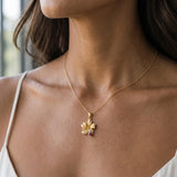 14k 15mm Hibiscus Pendant with 2 Diamonds and Ruby — worn on model (brunette, view 2)