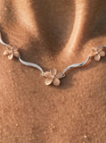 14k 2/tone Plumeria Lei Necklace with 5 diamonds — studio macro closeup on model (brunette)