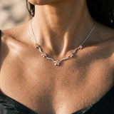 14k 2/tone Plumeria Lei Necklace with 5 diamonds — worn on model (brunette, view 3)