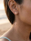 14k 7mm Plumeria Earrings with 6 Diamonds — close-up on model