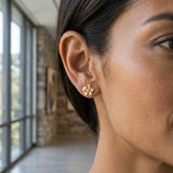 14k 11mm Plumeria Earrings with 2 Diamonds — worn on model (brunette, view 2)