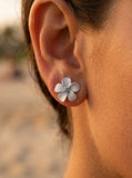 14kw/g 11mm Plumeria Earrings with 2 blue diamonds — close-up on model