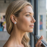 14kw/g 11mm Plumeria Earrings with 2 blue diamonds — worn on model (blonde, view 2)