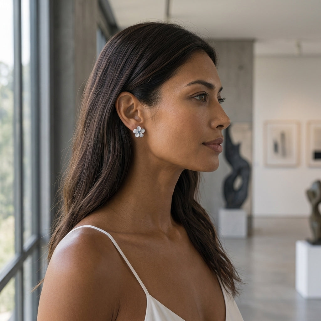 14kw/g 11mm Plumeria Earrings with 2 blue diamonds — worn on model (brunette, view 2)