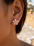 14k 8mm Plumeria Earrings with 2 Diamonds — close-up on model