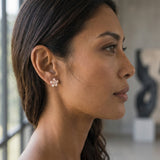 14k 8mm Plumeria Earrings with 2 Diamonds — worn on model (brunette, view 1)