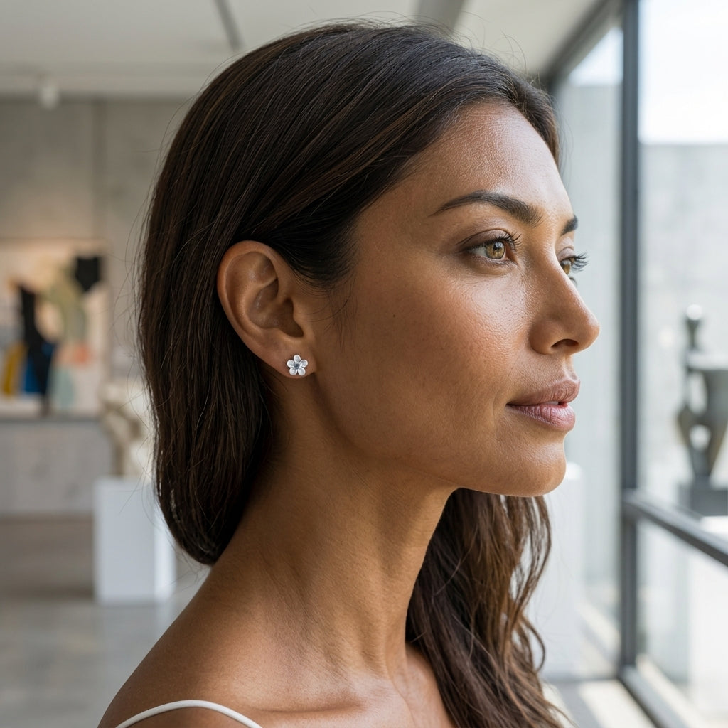 8mm 14k Plumeria Earring with 2 blue diamonds — worn on model (brunette, view 1)