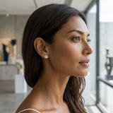 8mm 14k Plumeria Earring with 2 blue diamonds — worn on model (brunette, view 1)