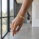 11mm 14k Plumeria Bracelet with 13 diamonds and 13 flowers — worn on model (brunette, view 1)