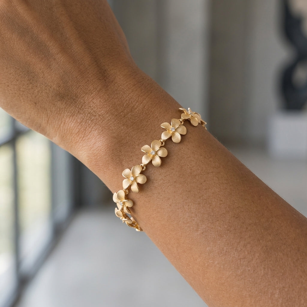 11mm 14k Plumeria Bracelet with 13 diamonds and 13 flowers — worn on model (brunette, view 2)