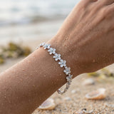 14k 08mm Plumeria Bracelet with 18 diamonds and 18pc flowers — worn on model (brunette, view 3)