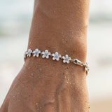 14k 08mm Plumeria Bracelet with 18 diamonds and 18pc flowers — worn on model (brunette, view 4)