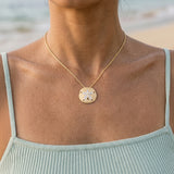 14k 25mm Sand Dollar Pendant with 12 Diamonds — worn on model (brunette, view 3)