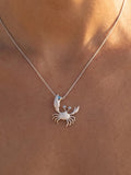 14k 22mm Crab Pendant with 3 Blue Diamonds — close-up on model