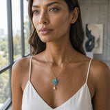 14K Yellow Gold with Pearl Three Seahorses Pendant — worn on model (brunette, view 1)