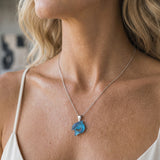 14K White Gold Dolphin Pendant — worn on model (blonde, macro close-up)