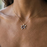 14k 2/tone 12mm "Hawaiian Petroglyph" Honu Pendant with 2 Diamonds and 15 Blue Sapphires — worn on model (brunette, view 2)