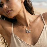 14k 2/tone Crab Pendant with 2 Diamonds and 14 Pastel Blue Sapphires — worn on model (brunette, view 3)