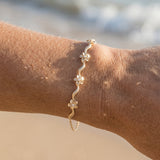 14k Plumeria Lei Bracelet with 6 diamonds — worn on model (blonde, view 4)