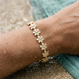 14k 11mm Plumeria Bracelet 7" with 13 diamonds and 13pc flowers — worn on model (brunette, view 4)