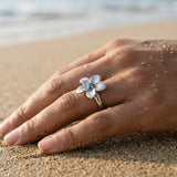 13mm 14k Plumeria Ring with blue diamond — worn on model (brunette, view 4)