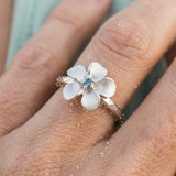 14k 10mm Plumeria Ring with blue diamond — worn on model (blonde, view 4)