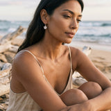 8mm 14kw Plumeria Earrings with 2 diamonds — worn on model (brunette, view 1)
