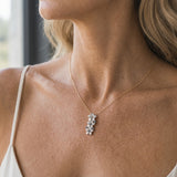 6, 8 & 10mm 14k Plumeria Lei Slide Pendant with 3 blue diamonds — worn on model (blonde, view 2)